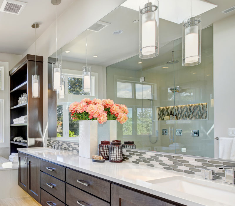 Bathroom with a large frameless mirror