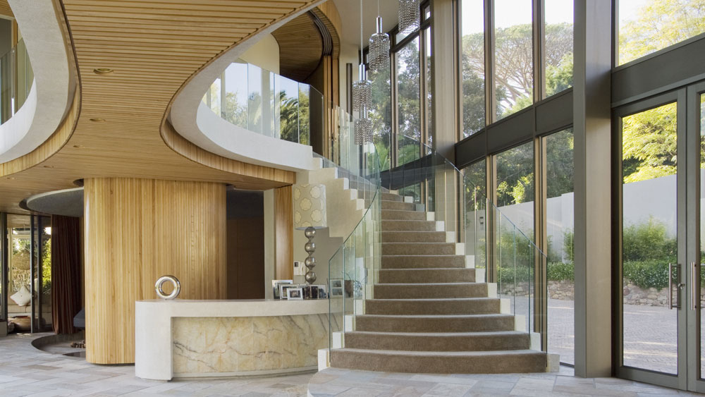 Large-windows-and-glas-railing Large lobby with glass windows and halfway glass railings going up the stairs and along the second floor