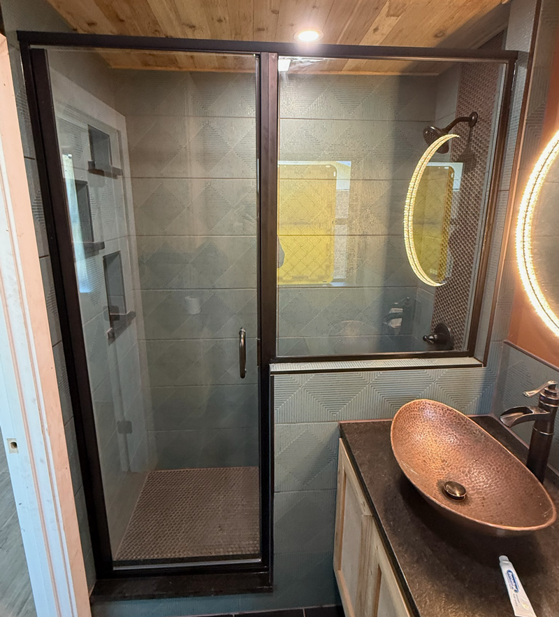 rustic-bathroom A rustic styled bathroom with glass sliding doors on the shower